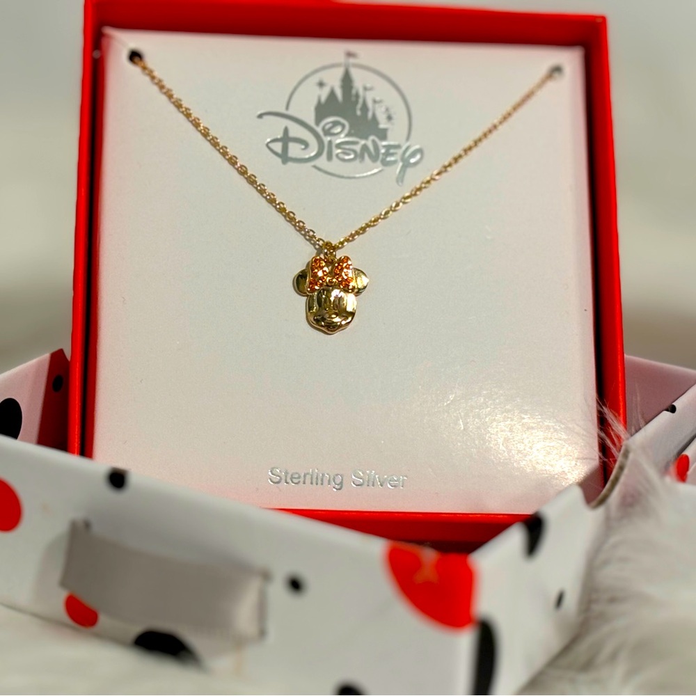 Authentic Disney Minnie Mouse gold tone necklace accented with pink crystal bow.